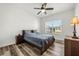 Cozy bedroom with ceiling fan, wood-look flooring, and ample natural light at 6566 S Goldenrod Rd # 82A, Orlando, FL 32822