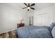 Bedroom features ceiling fan, wood-look floors, double closet, and natural light at 6566 S Goldenrod Rd # 82A, Orlando, FL 32822
