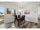 Cozy dining area with modern lighting and a view of the outdoor balcony at 6566 S Goldenrod Rd # 82A, Orlando, FL 32822