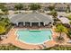 Inviting community pool with lounge chairs and covered seating area surrounded by lush landscaping at 6566 S Goldenrod Rd # 82A, Orlando, FL 32822