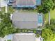 An aerial view of the house showcases its screened-in pool and green surroundings in a residential neighborhood at 6720 Winder Lynne Ln, Orlando, FL 32819