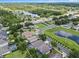 Aerial view showcases a quaint neighborhood with lush landscaping and a serene pond, nestled in a vibrant community at 6720 Winder Lynne Ln, Orlando, FL 32819