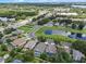 Beautiful aerial view of a residential neighborhood with tree-lined streets and a small lake in a sunny, suburban setting at 6720 Winder Lynne Ln, Orlando, FL 32819