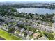 Aerial view highlights lakeside homes in a verdant community with lush landscaping and calm streets for a tranquil setting at 6720 Winder Lynne Ln, Orlando, FL 32819