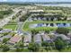 A neighborhood street view highlights a house with a screened-in pool, set against a backdrop of trees and a lake at 6720 Winder Lynne Ln, Orlando, FL 32819