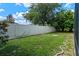 Well-kept backyard with a white fence and lush green lawn, offering a serene outdoor space at 6720 Winder Lynne Ln, Orlando, FL 32819