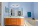 Bright bathroom features a double sink vanity, soaking tub, and great lighting at 6720 Winder Lynne Ln, Orlando, FL 32819