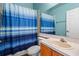 Bathroom featuring vanity and blue curtained shower at 6720 Winder Lynne Ln, Orlando, FL 32819