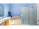 Bright bathroom features a soaking tub and separate glass shower at 6720 Winder Lynne Ln, Orlando, FL 32819