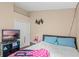 Cozy bedroom with wall mounted television and comfortable bed at 6720 Winder Lynne Ln, Orlando, FL 32819