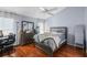 Comfortable bedroom with natural light, ceiling fan, and dark wood floors at 6720 Winder Lynne Ln, Orlando, FL 32819