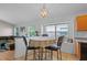 Bright dining nook featuring natural light, an adjacent living space, and bar style dining at 6720 Winder Lynne Ln, Orlando, FL 32819