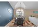 Inviting dining area featuring a decorative mirror, a large window, and a stylish chandelier at 6720 Winder Lynne Ln, Orlando, FL 32819