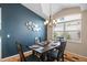 Formal dining area featuring a modern chandelier, neutral walls, and seating for four at 6720 Winder Lynne Ln, Orlando, FL 32819
