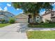Inviting home with a well-manicured lawn, spacious driveway, and mature tree providing ample shade at 6720 Winder Lynne Ln, Orlando, FL 32819
