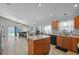 Bright kitchen with central island, stainless steel appliances, and a view to the backyard at 6720 Winder Lynne Ln, Orlando, FL 32819