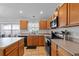 Well-equipped kitchen featuring oak cabinets, modern appliances, and ample counter space at 6720 Winder Lynne Ln, Orlando, FL 32819