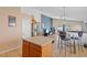 Eat-in kitchen featuring a stainless steel refrigerator, island, and four-chair dining set at 6720 Winder Lynne Ln, Orlando, FL 32819