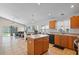 Bright kitchen with a central island, modern appliances, and an open view to the living area at 6720 Winder Lynne Ln, Orlando, FL 32819
