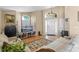 Cozy living space with tile flooring, natural light and a view to the front entry at 6720 Winder Lynne Ln, Orlando, FL 32819