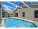 Sparkling pool with tiled entry steps and a screened enclosure, offering a private oasis at 6720 Winder Lynne Ln, Orlando, FL 32819