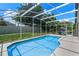This screened-in pool sparkles with blue water, offering a private oasis for relaxation and entertainment at 6720 Winder Lynne Ln, Orlando, FL 32819