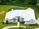 Aerial view of a home featuring a circular driveway, screened-in pool, and well-manicured landscaping at 740 Bear Creek Cir, Winter Springs, FL 32708
