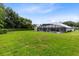 Expansive backyard with lush green lawn and tall trees, offering a private outdoor space at 740 Bear Creek Cir, Winter Springs, FL 32708