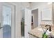 Bathroom with a glass shower stall, granite vanity, a view into the adjacent bedroom, and tiled walls at 740 Bear Creek Cir, Winter Springs, FL 32708