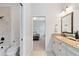 Bright bathroom featuring a soaking tub, granite vanity, and a doorway to the adjacent bedroom at 740 Bear Creek Cir, Winter Springs, FL 32708