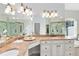 Bathroom showcasing double vanity with granite countertops, soaking tub, and glass enclosed shower at 740 Bear Creek Cir, Winter Springs, FL 32708