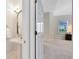 Bathroom featuring a pedestal sink, decorative mirror, and an entrance to the adjacent bedroom space at 740 Bear Creek Cir, Winter Springs, FL 32708