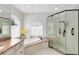 Bathroom features a soaking tub with granite surround and a glass-enclosed shower at 740 Bear Creek Cir, Winter Springs, FL 32708