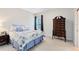 Light-filled bedroom with a floral-patterned bed, large chest of drawers, neutral carpet, and a window at 740 Bear Creek Cir, Winter Springs, FL 32708