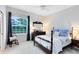 Cozy bedroom with a four-poster bed, dresser, and large window offering natural light at 740 Bear Creek Cir, Winter Springs, FL 32708