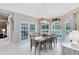 Bright dining room with pool view, decorative light fixture, and a table set for a cozy meal at 740 Bear Creek Cir, Winter Springs, FL 32708