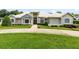 Beautiful home featuring manicured landscaping, expansive lawn, and a circular driveway at 740 Bear Creek Cir, Winter Springs, FL 32708
