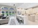 Open-concept kitchen featuring a large center island, seating, and seamless transition into the living area at 740 Bear Creek Cir, Winter Springs, FL 32708