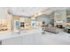 Beautiful kitchen with a large island, and a seamless open layout to the fireplace-centered living room at 740 Bear Creek Cir, Winter Springs, FL 32708