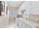 Clean laundry room with white cabinets, a window, a washer, a dryer, and light-colored walls at 740 Bear Creek Cir, Winter Springs, FL 32708