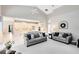Open-concept living room showcasing neutral decor and cathedral ceilings next to a modern, bright kitchen at 740 Bear Creek Cir, Winter Springs, FL 32708