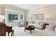 Formal living room with bay windows, fireplace and a comfortable seating area with a soft color palette at 740 Bear Creek Cir, Winter Springs, FL 32708