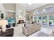 Spacious living room with fireplace, built-in shelves, and view to the outdoor dining area at 740 Bear Creek Cir, Winter Springs, FL 32708