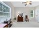 Bright office featuring large window, desk with shelving, antique chair, and light-colored walls at 740 Bear Creek Cir, Winter Springs, FL 32708