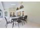 Covered outdoor patio featuring tile flooring, a large table with chairs, and views of the backyard at 740 Bear Creek Cir, Winter Springs, FL 32708
