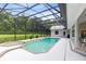 Screened in pool area with an outdoor hot tub and view of backyard greenery at 740 Bear Creek Cir, Winter Springs, FL 32708