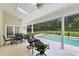 Inviting covered outdoor patio space with a pool, a jacuzzi, multiple ceiling fans, and outdoor furniture at 740 Bear Creek Cir, Winter Springs, FL 32708
