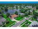Overhead view of a well-maintained neighborhood with a large pond, mature trees, and lush landscaping at 800 Sterling Chase Dr, Port Orange, FL 32128