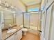 Bright bathroom vanity with granite countertops, a white vessel sink, and a sliding glass door shower at 800 Sterling Chase Dr, Port Orange, FL 32128