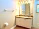 Bathroom vanity featuring granite countertops, white cabinets, and ample lighting at 800 Sterling Chase Dr, Port Orange, FL 32128